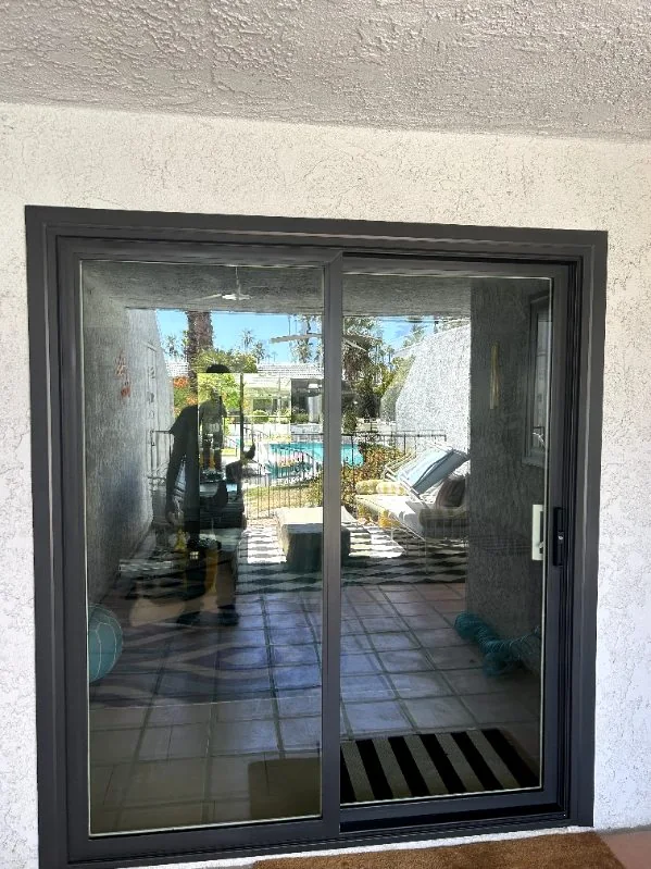 Black frame sliding door out to the pool, RJ Construction