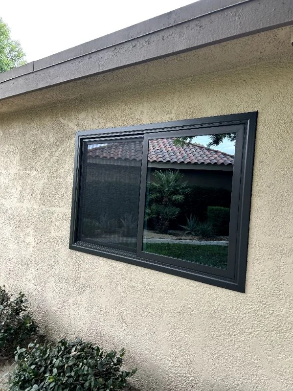 Black slider window, trimmed into the stucco, RJ Construction